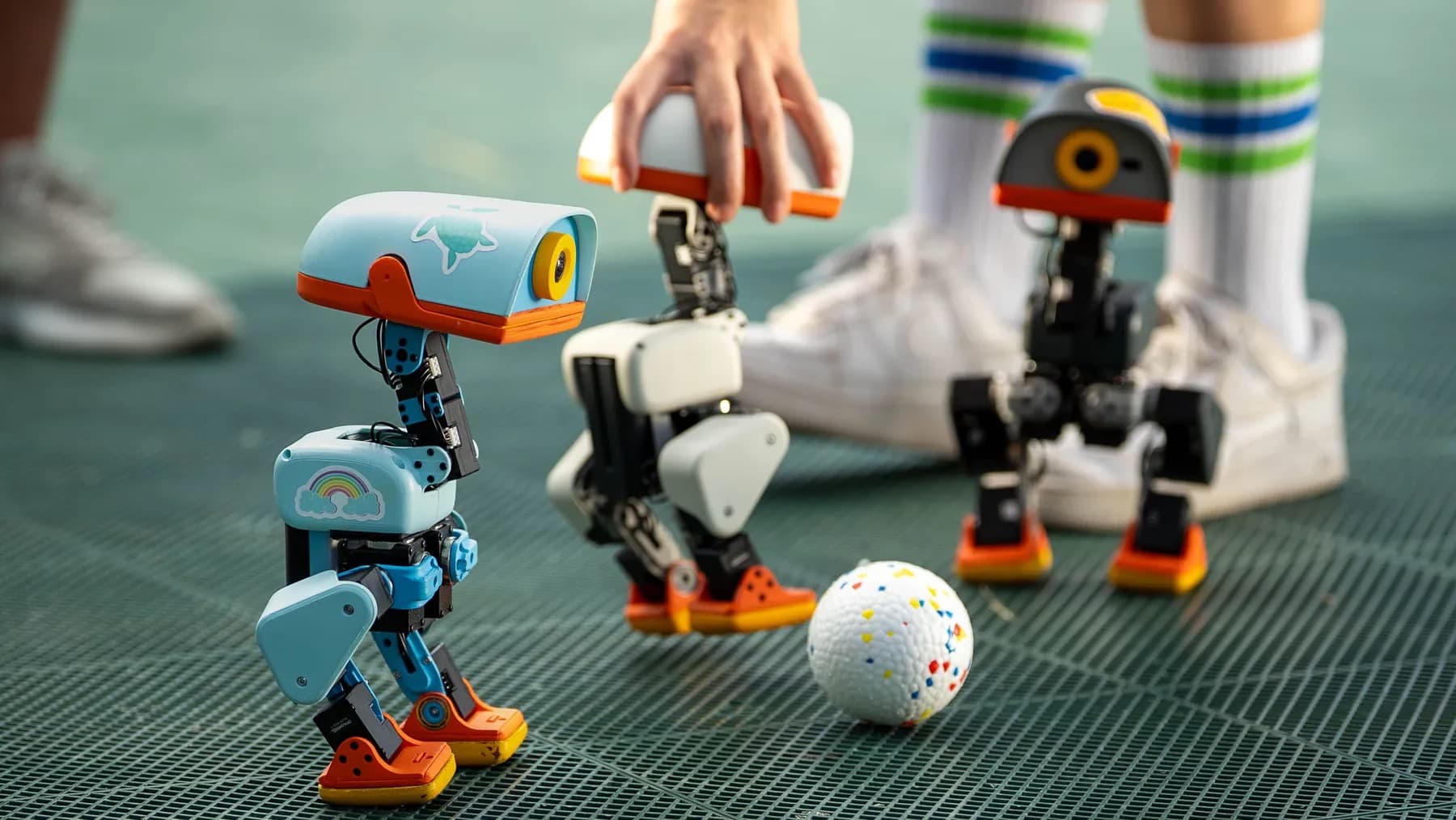 Microduck kicking a ball